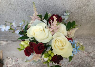 bridesmaid bouquet with white, ivory, blush, blue, and burgundy flowers
