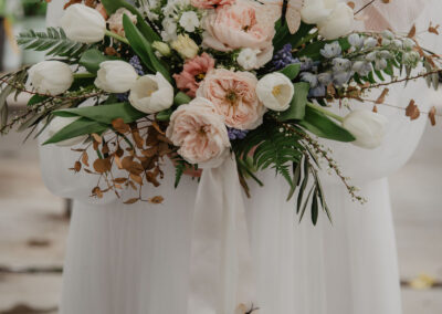 peach, blush, pale blue, and white bridal bouquet